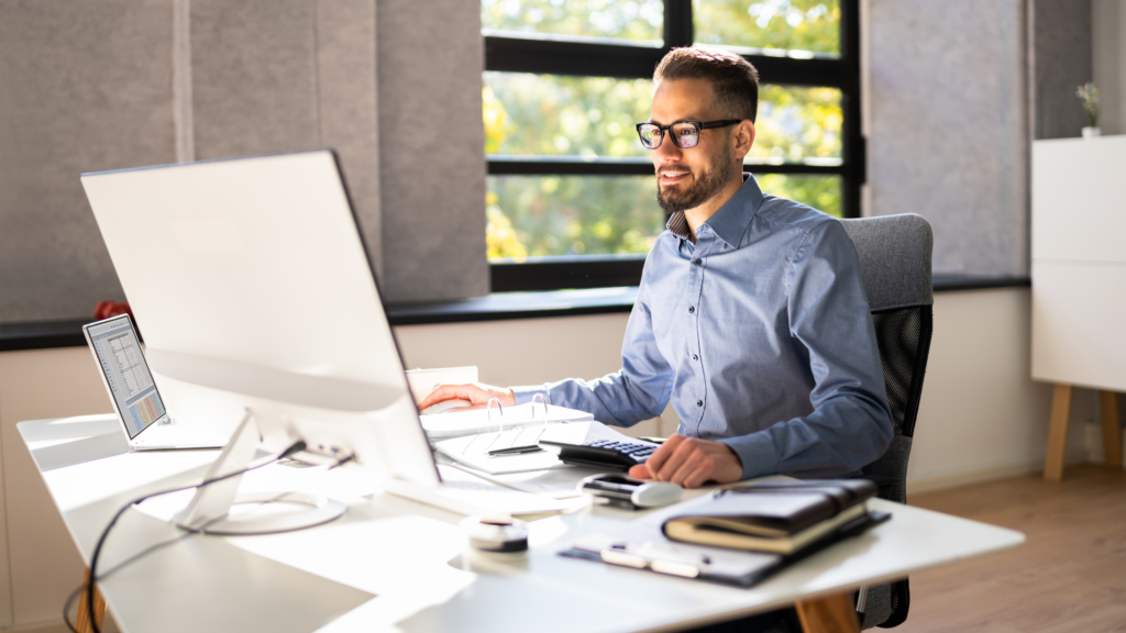 Accountant managing business listings and citations on desktop computer