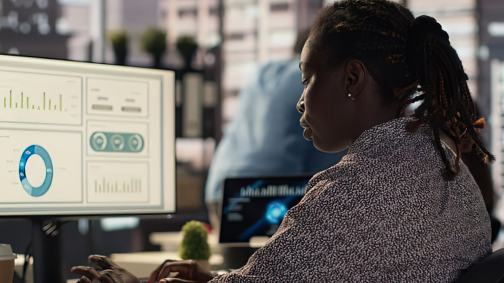 Accountant monitoring conversion data charts on office computer screen