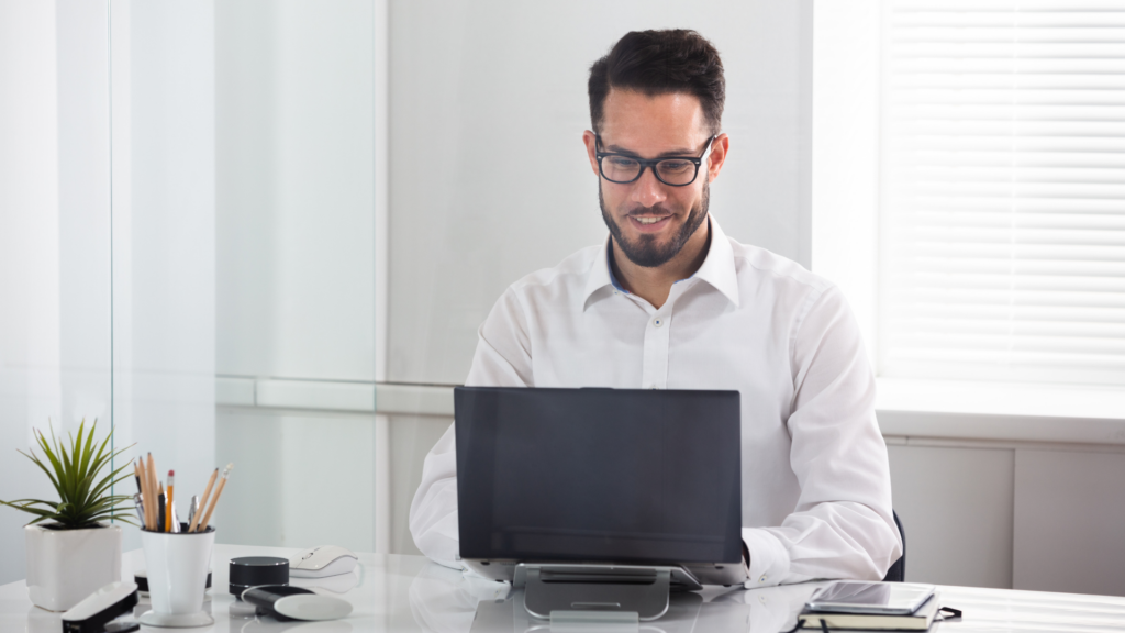 Agent working on multi location property listings from office desk
