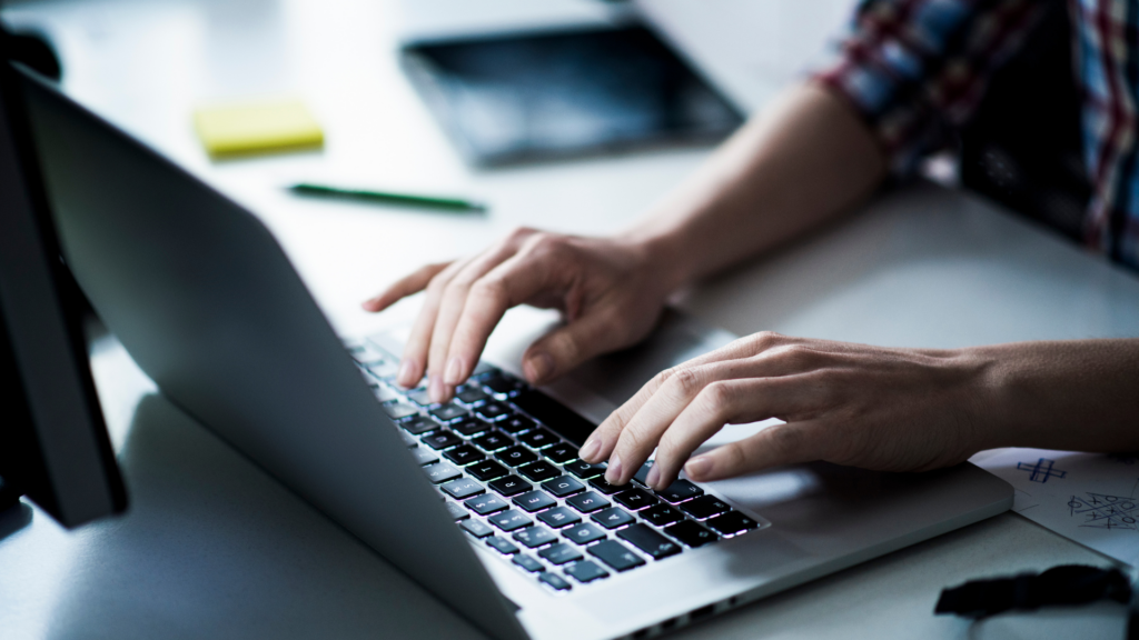 Business owner drafting profile details on a laptop