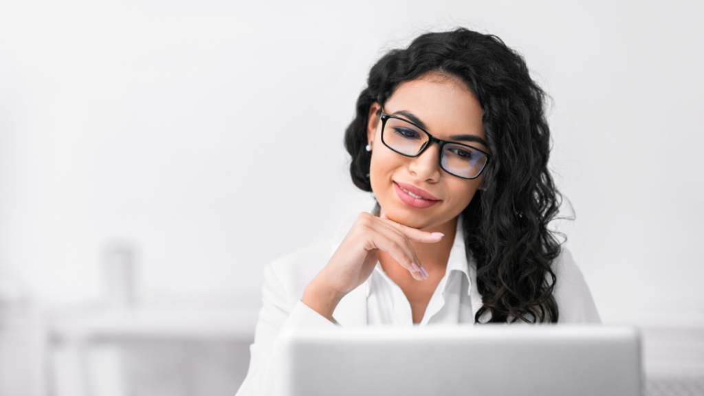 Business owner thoughtfully reading customer reviews on laptop