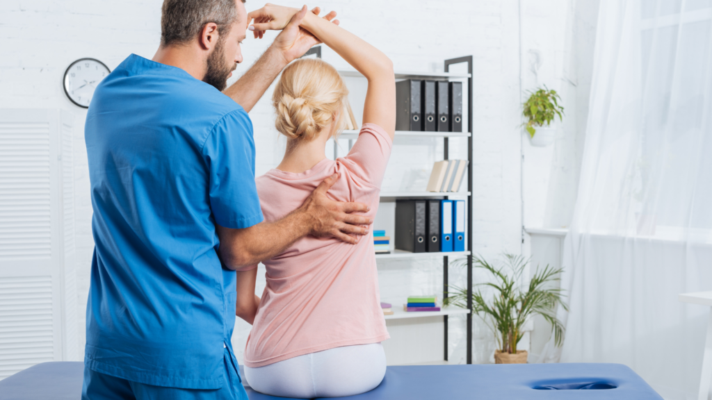 Chiropractor helping a patient stretch during a treatment session