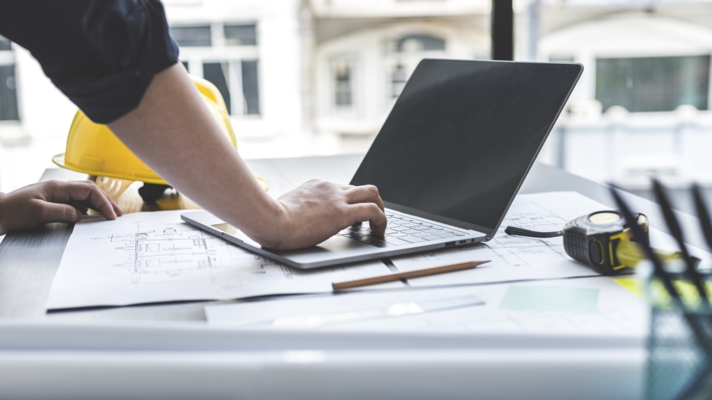 Contractor managing online reviews and profile updates on laptop