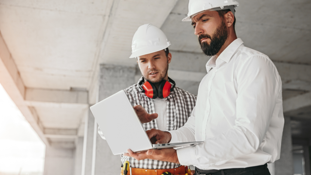 Contractors discussing local leads and search visibility on laptop