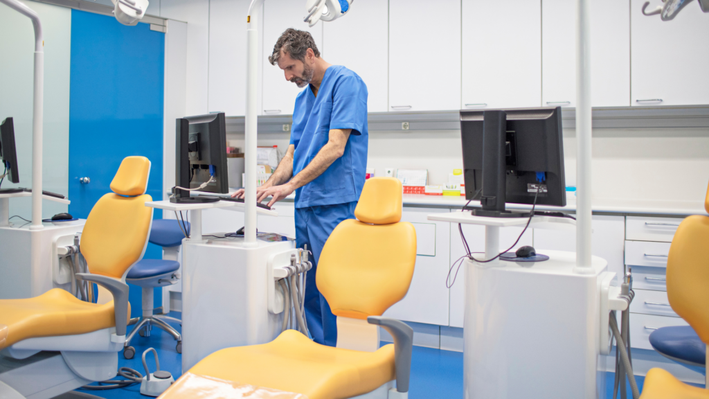 Dental professional checking patient review activity on office computer