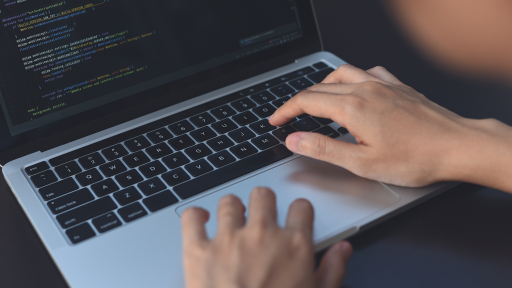 Developer editing JavaScript source code on a laptop