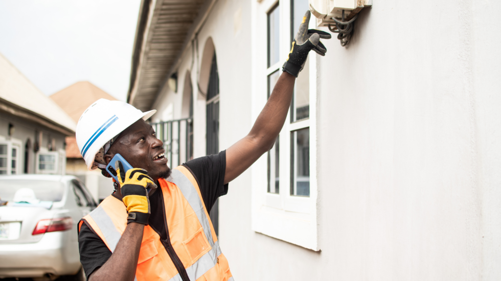 Electrician answering a local service call while inspecting a unit