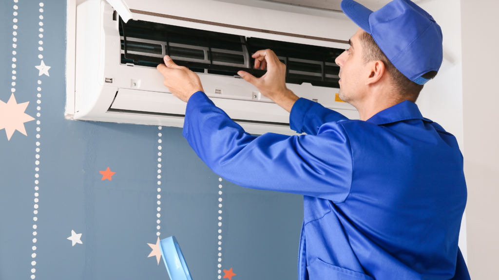 HVAC technician servicing an indoor air conditioning unit