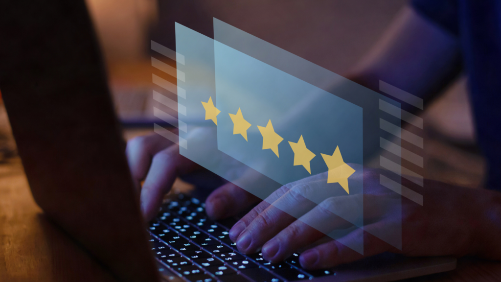 Hands on keyboard with star rating symbols representing customer feedback
