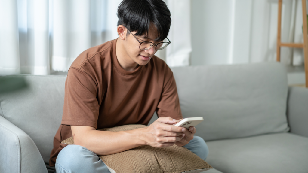 Man checking a restaurant website on his phone at home