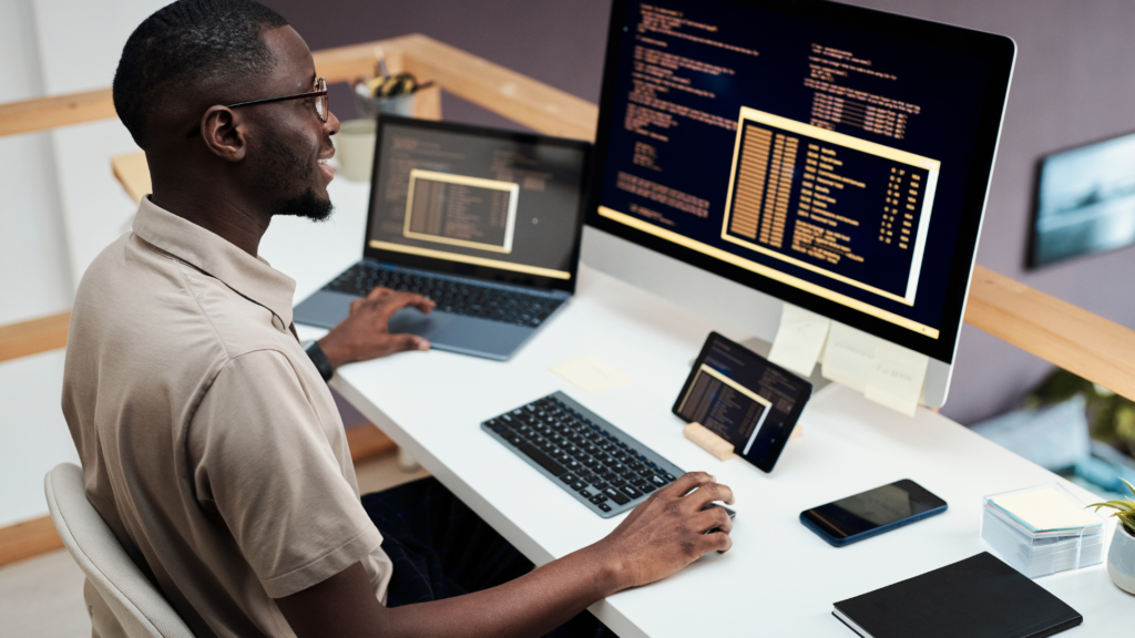 Programmer analyzing rendered code output on desktop monitor