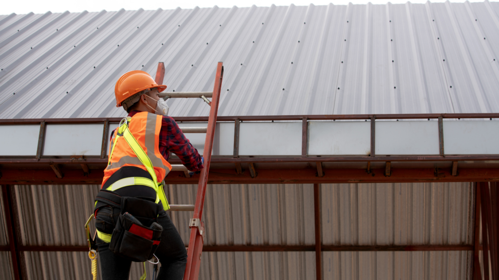 Roofing contractor preparing to inspect a metal rooftop