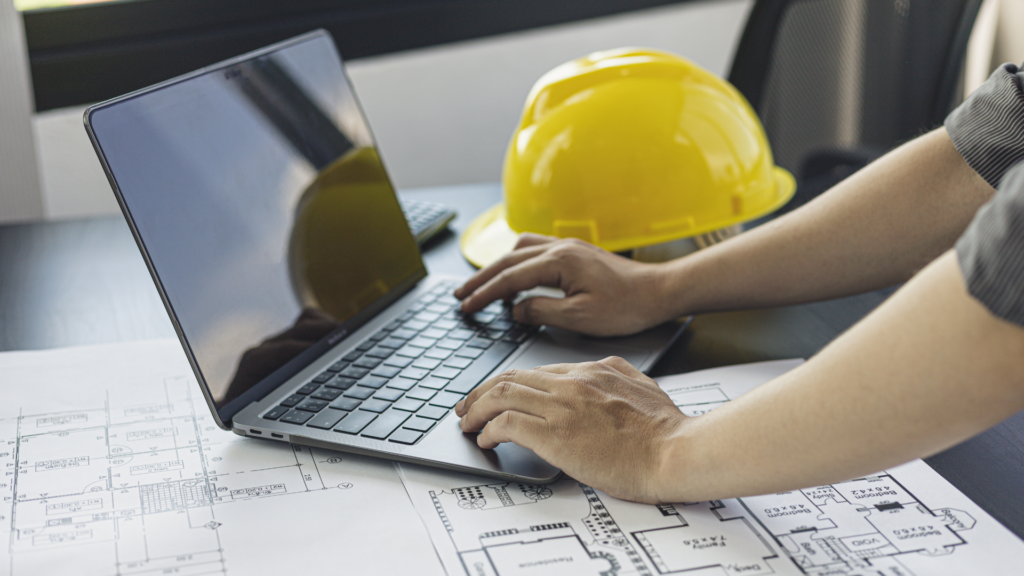 Roofing professional browsing website content near construction plans