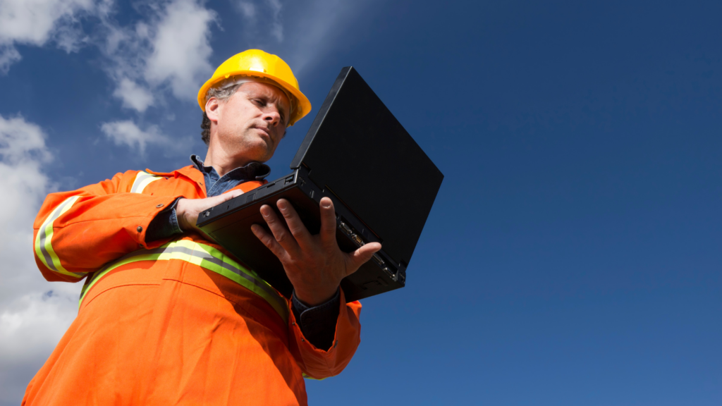 Worker in safety gear reviewing website rankings outdoors