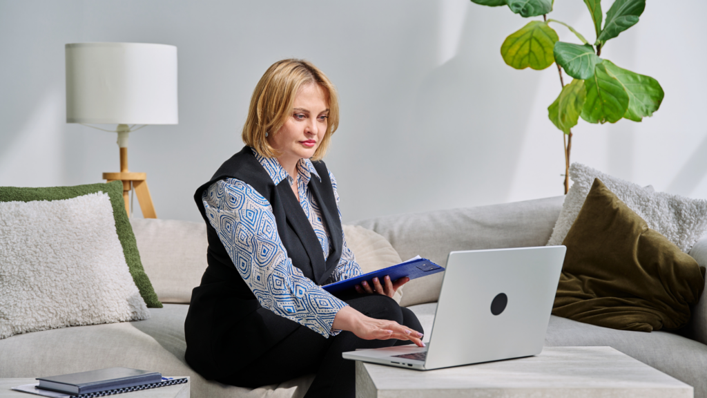 Counselor reviewing website content and client questions on laptop