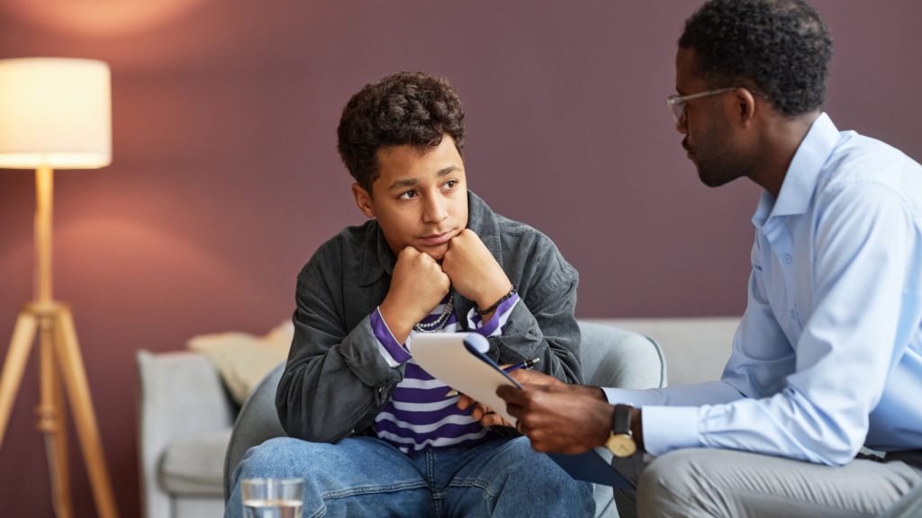 Counselor speaking with a teenage client seeking mental health support