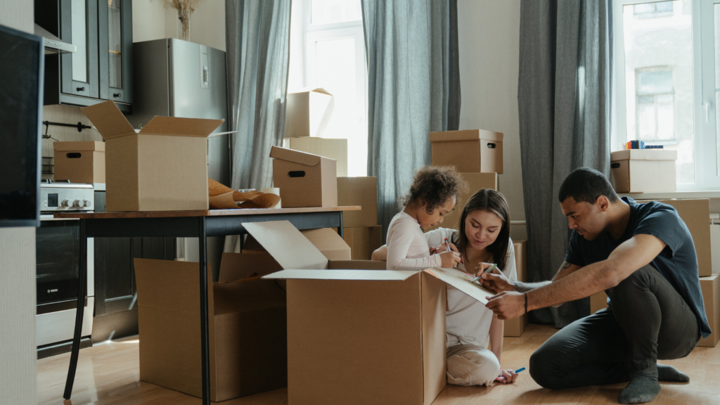 Family packing boxes together before their upcoming local move