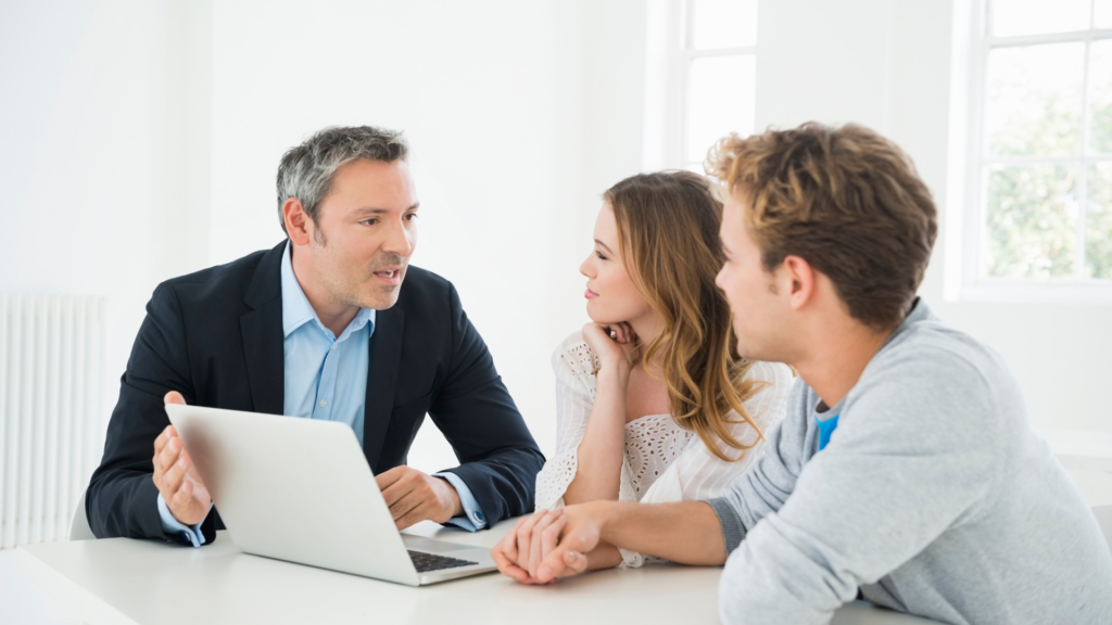 Financial advisor guiding a couple through investment planning decisions
