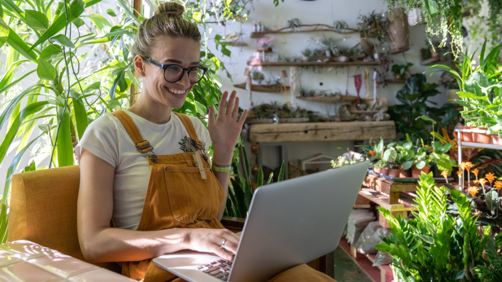 Landscaping business owner checking website performance on laptop