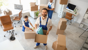 Professional movers carrying boxes during a commercial relocation