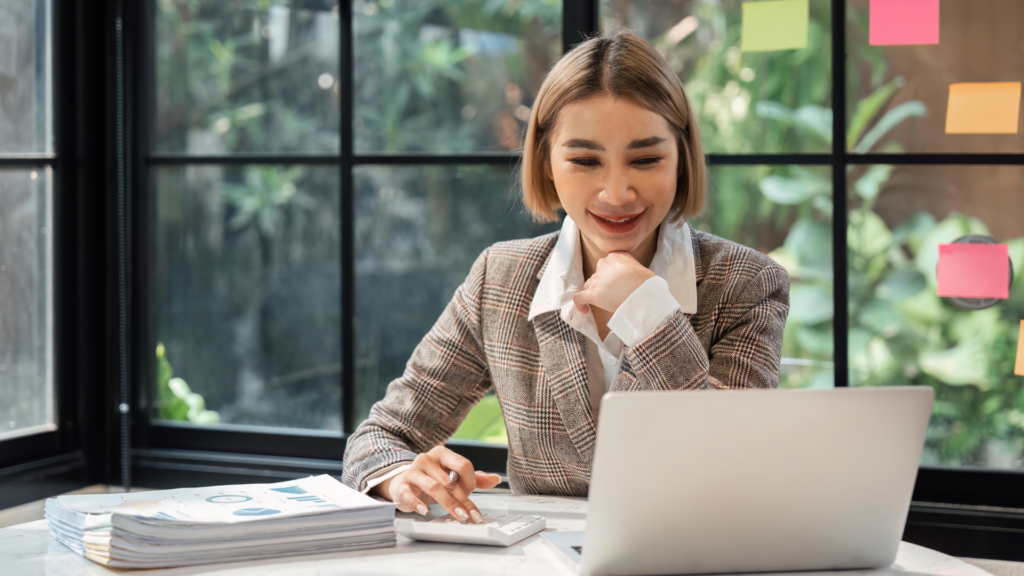 Professional working on a laptop to plan client outreach