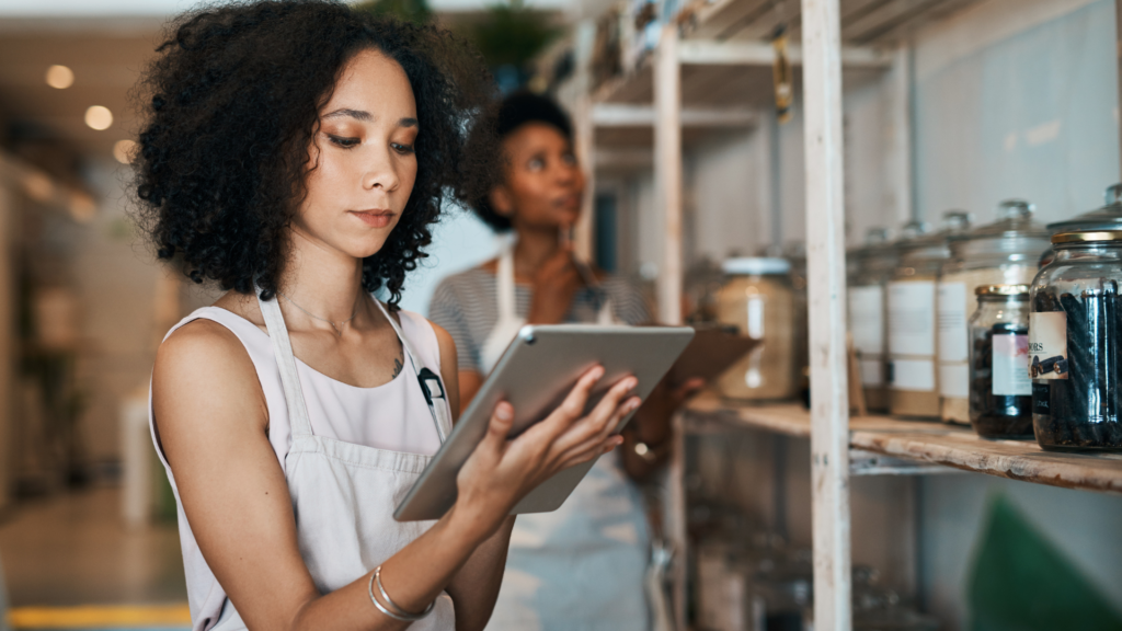 Retail staff reviewing feedback and ratings on a tablet device