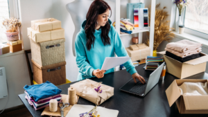 Small business owner reviewing details before shipping customer orders