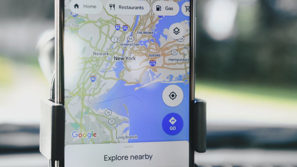 Smartphone mounted in car displaying Google Maps navigation screen