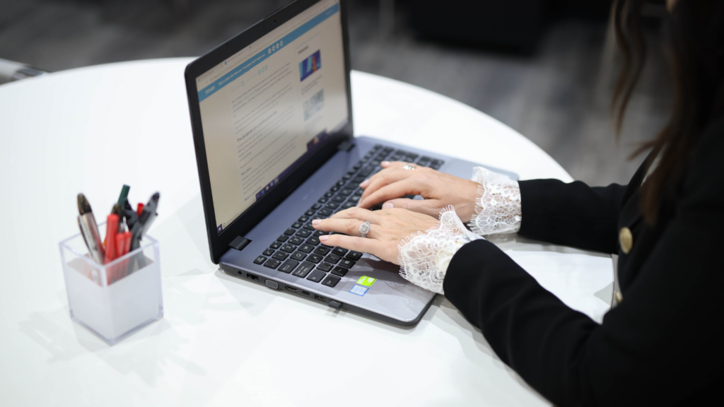 Woman typing while exploring local link building resources on laptop