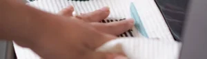 person cleaning a surface with a Swededishcloths
