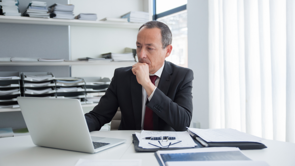 Business owner reviewing monthly ranking results on a laptop at his desk