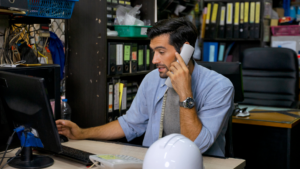 Local service company owner answering a customer call at his desk