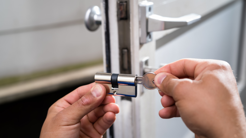Locksmith holding a lock cylinder for a locked out customer’s door