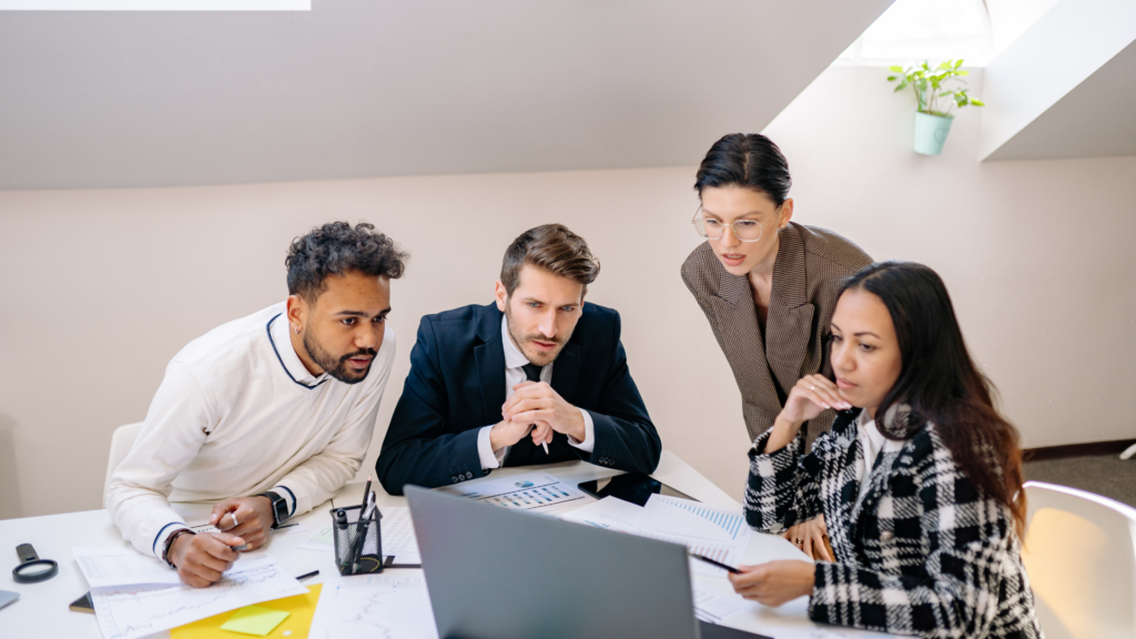 Marketing team comparing local search rankings across different areas on laptop