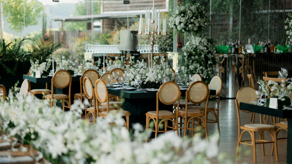 Outdoor venue set for an event with white floral centerpieces