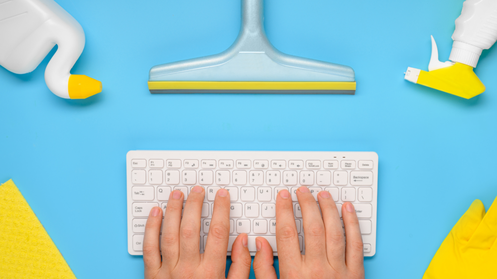 Owner updating cleaning business website details on a keyboard near supplies