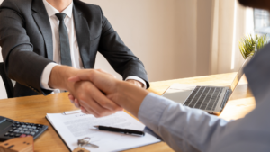 Property manager and tenant shake hands after filling a vacancy