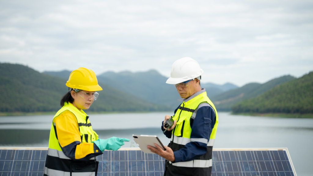 Solar installers discussing local marketing plans in front of a solar array