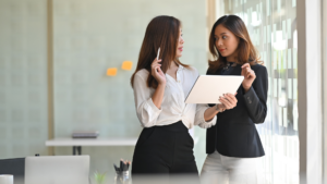 Two professionals planning how to improve local search visibility with a tablet