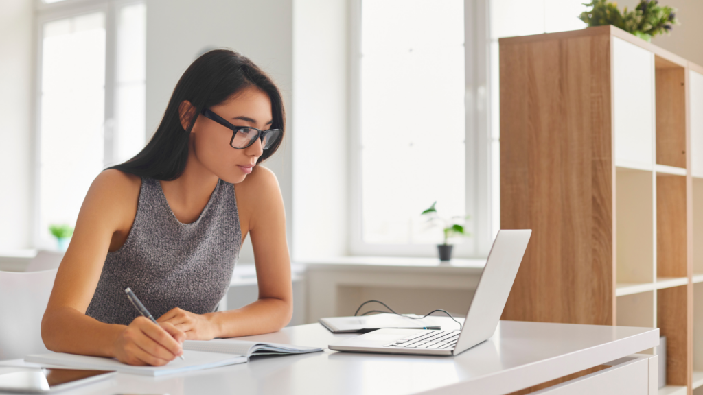 Woman reviewing an architecture firm’s profile and credentials on a laptop
